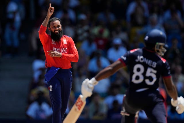 England’s Adil Rashid lifts his finger as he celebrates the dismissal of United States’ captain Aaron Jones,
