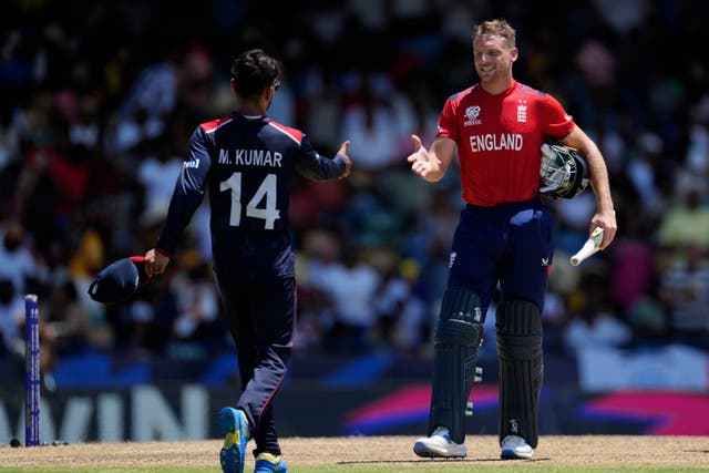 United States’ Milind Kumar walks to greet England captain Jos Buttler at the end of the World Cup match