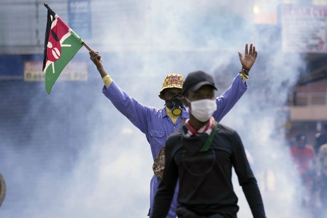 A protester raises a Kenyan flag