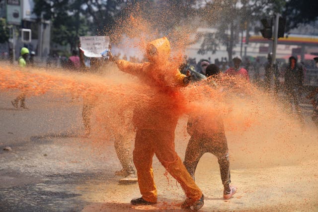 Protesters scatter as police spray a water cannon at them in Kenya 