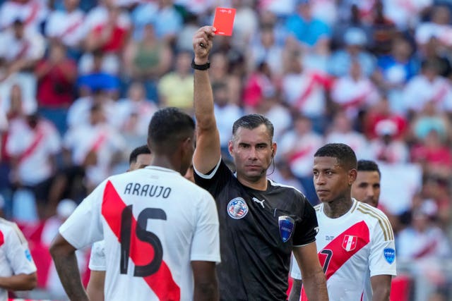 The referee shows Peru’s Miguel Araujo a red card during the Copa America match against Canada