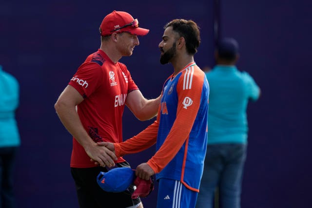 Virat Kohli, right, shakes hands with England’s captain Jos Buttler