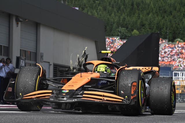 McLaren's Lando Norris arrives in the pits with a damaged right rear tyre during the Austrian Grand Prix