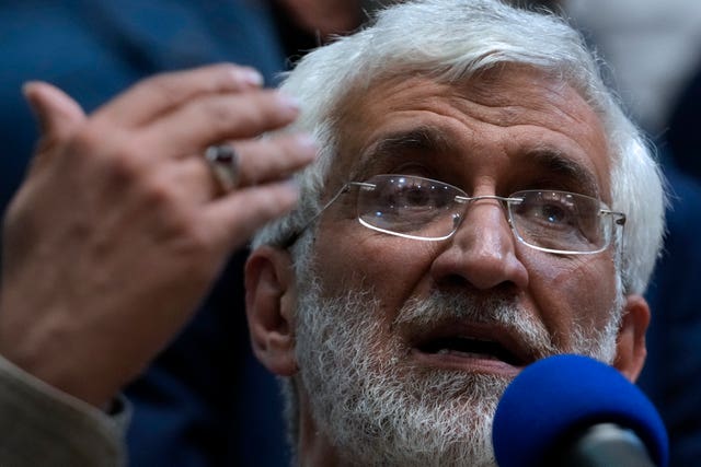Iranian presidential candidate Saeed Jalili, a hard-line former nuclear negotiator, speaks to a group of athlete supporters during a campaign stop at a sports hall in Tehran  Voters