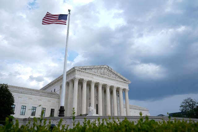The US Supreme Court building with American flag flying