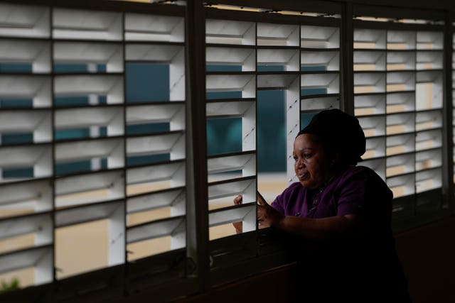 Donna Charles, a hotel cook, watches as Hurricane Beryl passes through Bridgetown, Barbados 