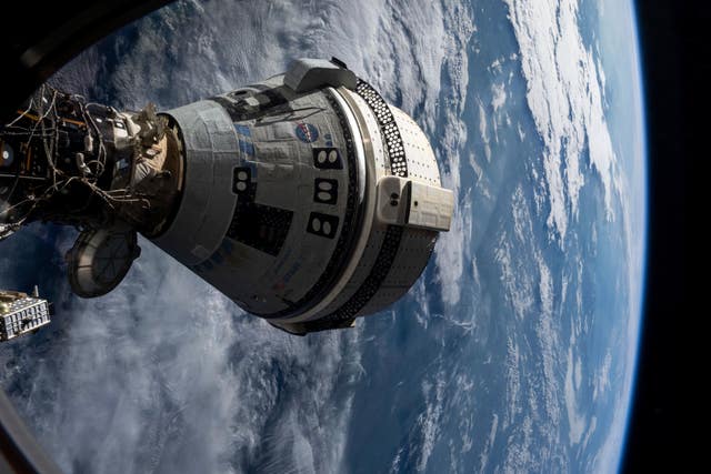 Boeing’s Starliner spacecraft is docked to the Harmony module of the International Space Station on July 3 2024, seen from a window on the SpaceX Dragon Endeavour spacecraft docked to an adjacent port