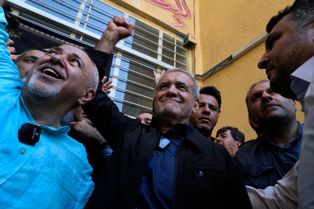 Mr Pezeshkian clenches his fist after casting his vote