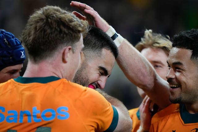 Australia’s Tom Wright, centre, is congratulated by team-mates after scoring a try