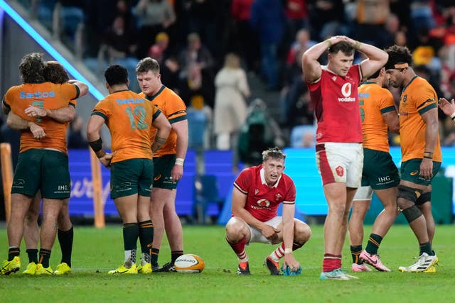 Wales players react following their defeat by Australia