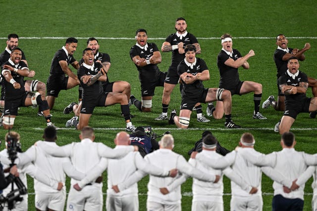 England’s players lock arms as New Zealand perform the haka
