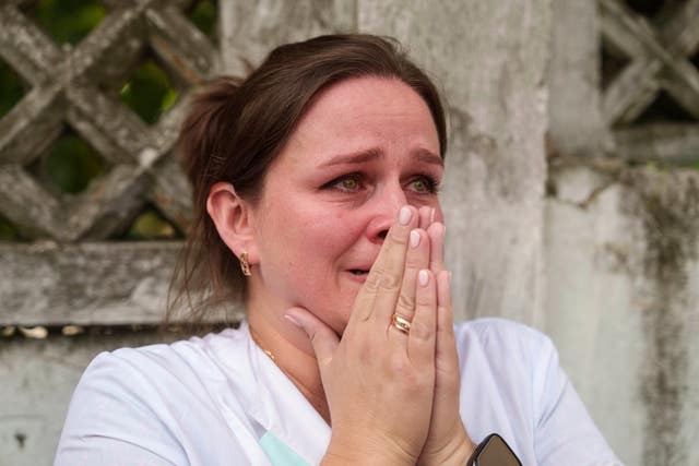 A woman reacts near the site of Okhmatdyt children’s hospital