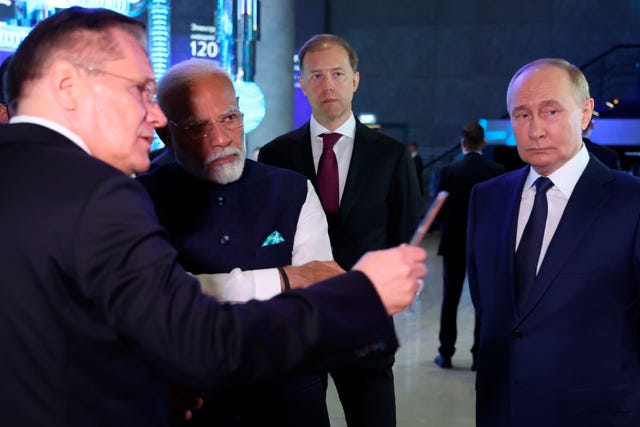 Russian State Atomic Energy Corporation Rosatom CEO Alexey Likhachev speaks to Narendra Modi and Vladimir Putin