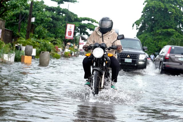 A motorcyclist on a flooded road 