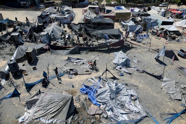 Palestinians inspect the damage at a site in Khan Younis in the southern Gaza Strip after an Israeli bombardment