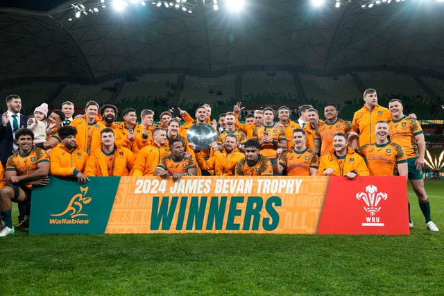 Australia pose with their trophy after defeating Wales