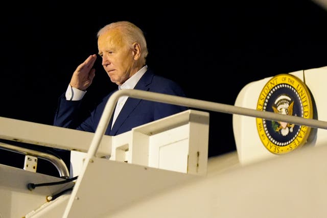 President Joe Biden salutes as he boards Air Force One