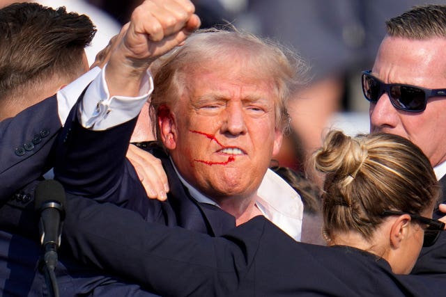 Republican presidential candidate former president Donald Trump reacts following an assassination attempt at the campaign event in Butler in July 