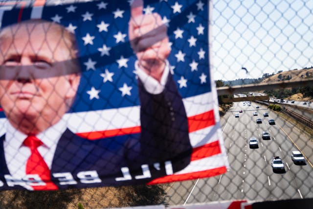 A banner of Donald Trump hangs over a Highway 24 overpass in Lafayette, 