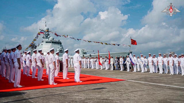 Russian military sailors attend a welcome ceremony of their joint naval forces exercise at a port in Zhanjiang 