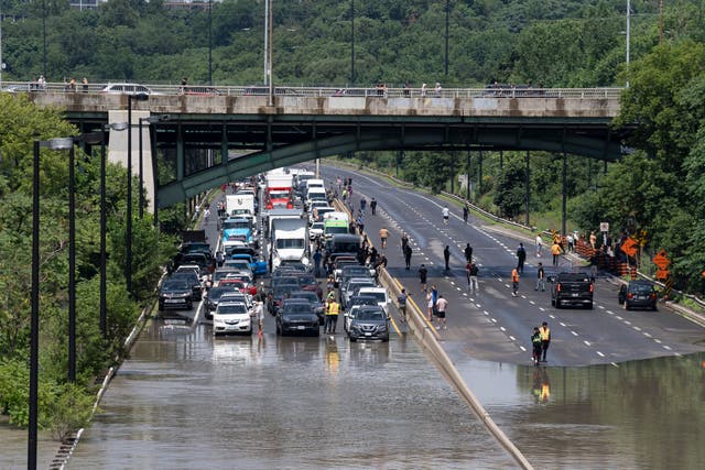 A car stops in front of a flooded road