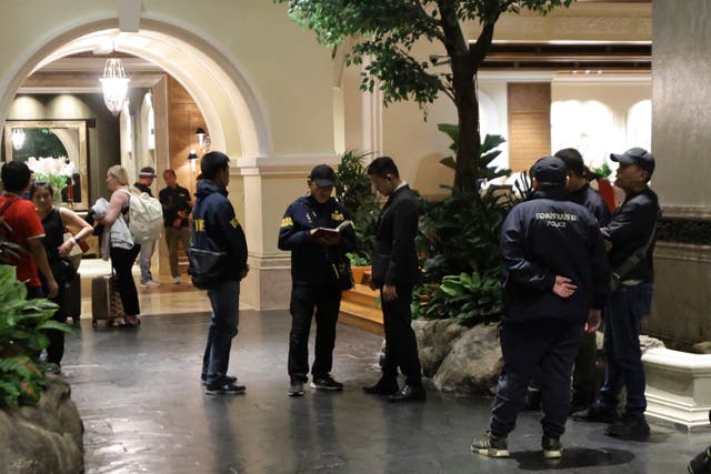 Police gather outside the Grand Hyatt Erawan Hotel in Bangkok