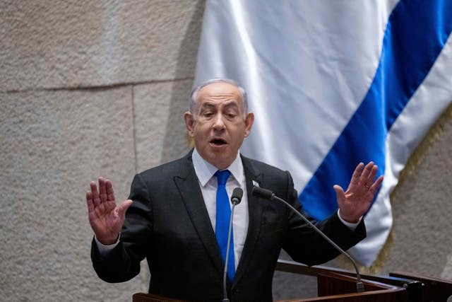 Benjamin Netanyahu next to Israeli flag