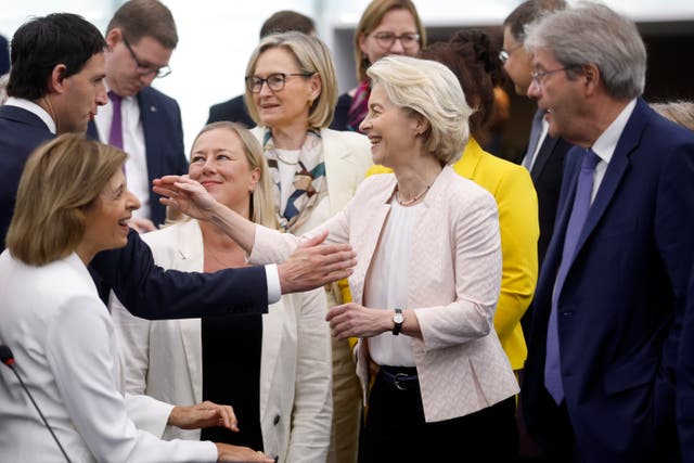 Ursula von der Leyen, centre, greets European commissioners as she arrives at the European Parliament on Thursday 