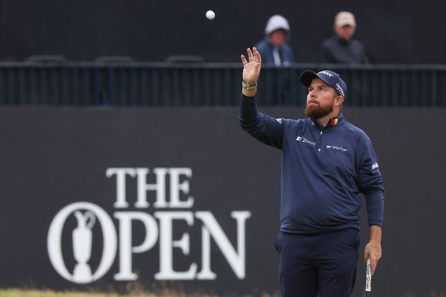 Shane Lowry holds his hand out to catch a ball