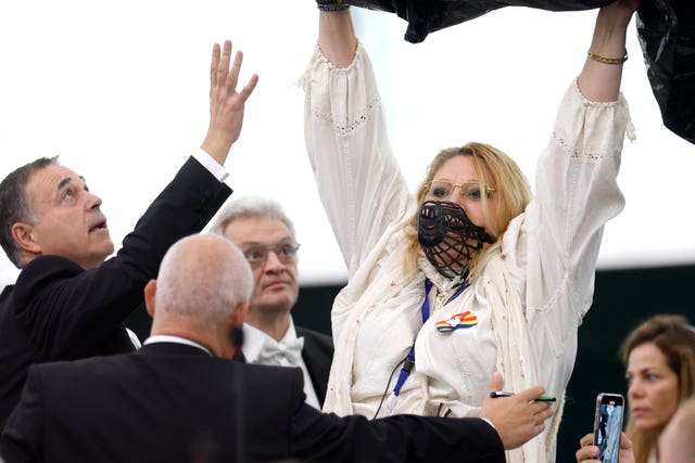 Member of European Parliament Diana Iovanovici-Sosoaca, centre right, wears a muzzle on her face during a debate in the parliament 