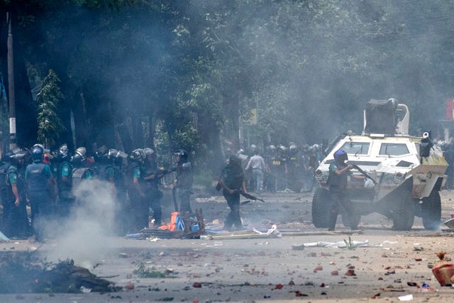 Police fire tear gas shells to disperse students protesting over a controversial quota system for government job applicants (Rajib Dhar/AP)