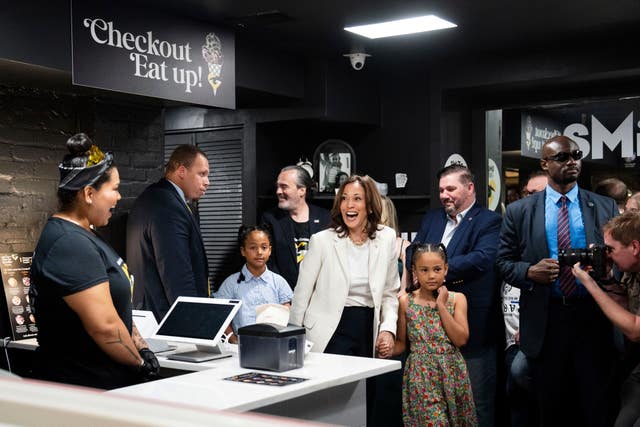 Kamala Harris, centre, surrounded by children and supporters