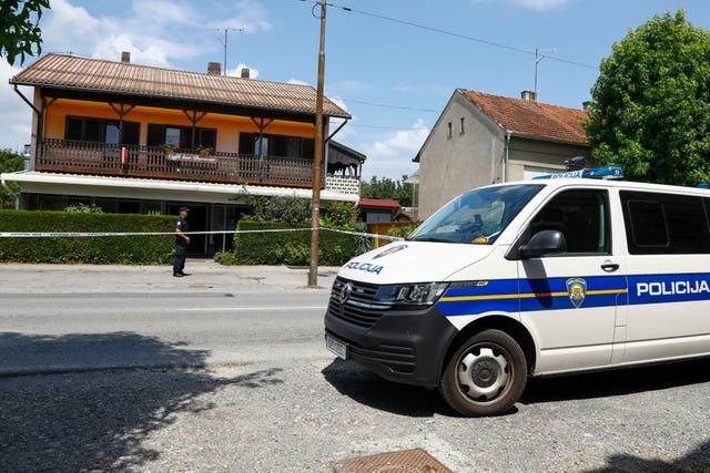 A police officer stands outside the cafe where the gunman was arrested