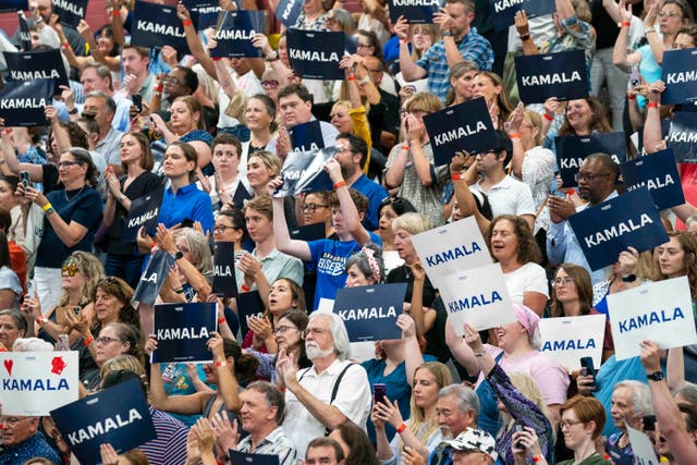 Supporters hold up flags in support of Kamala Harris