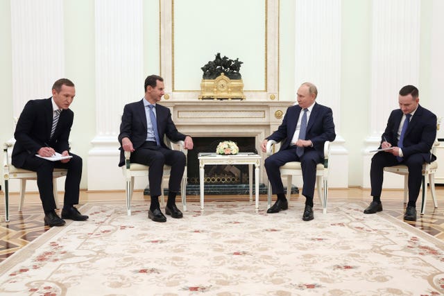 Bashar Assad, left, speaks with Vladimir Putin