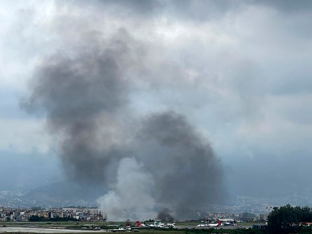 Smoke rises from the Tribhuvan International Airport in Kathmandu (Agniia Galdanova/AP)