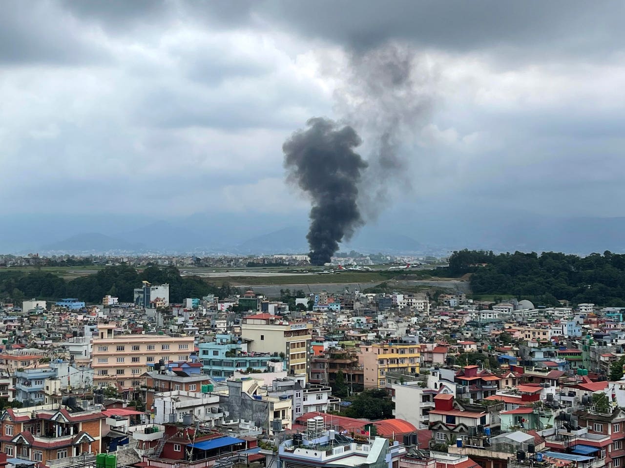 18 dead after plane slips off runway and crashes at Nepal airport