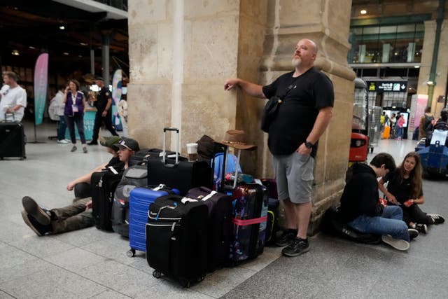 Passengers wait at the Gare du Nord station