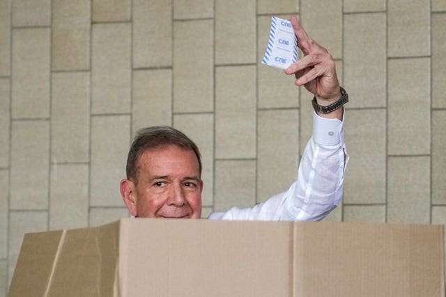 The opposition’s presidential candidate Edmundo Gonzalez shows his ballot as he votes in the presidential election in Caracas 