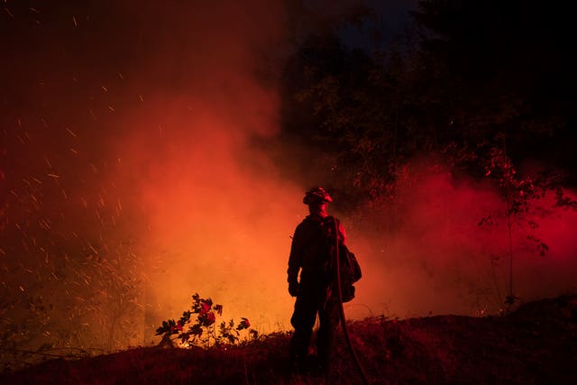 A firefighter from the city of Monterey monitors flareups from the Park Fire