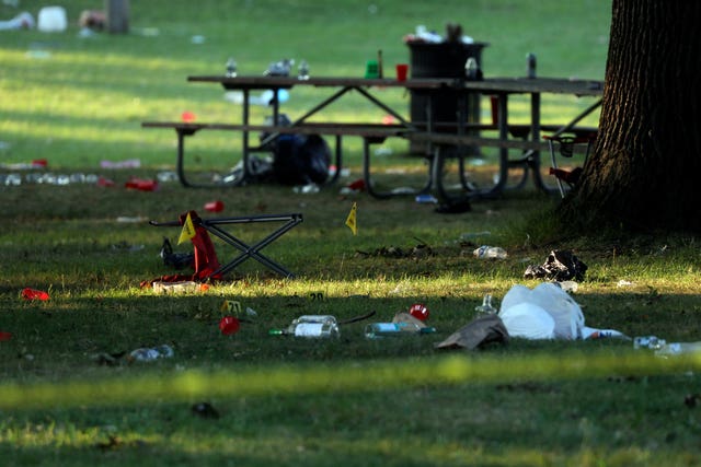 Debris is strewn about evidence markers in an area of Maplewood Park, Rochester, New York