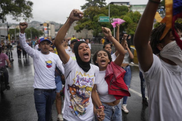 People protest the official election results declaring President Nicolas Maduro the winner of the presidential election, the day after the vote in Caracas