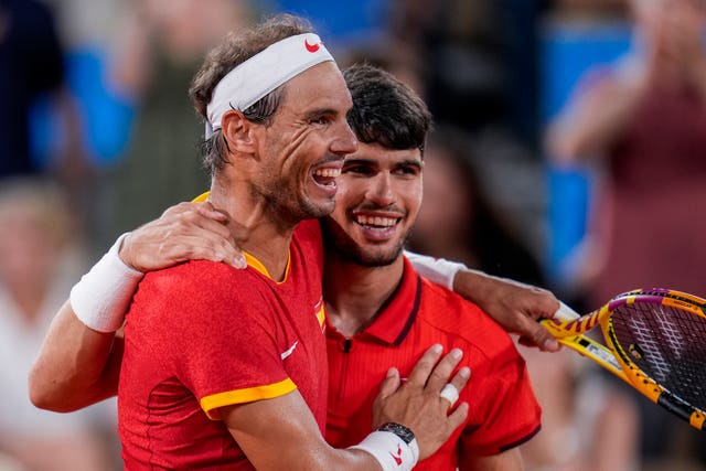 Rafael Nadal, left, and Carlos Alcaraz embrace 