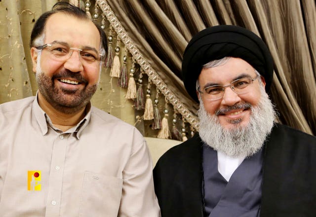 Hezbollah leader Hassan Nasrallah, right, with Fouad Shukur