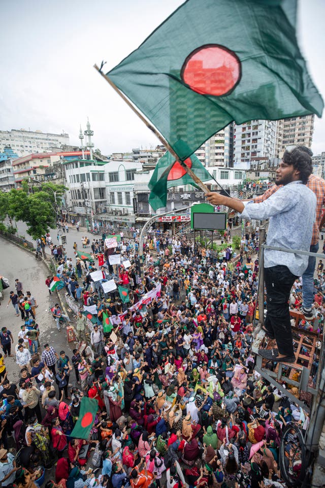 An activist waves a Bangladesh flag during a protest march