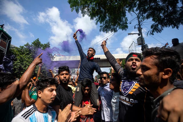 Protesters carrying flares celebrate in the streets