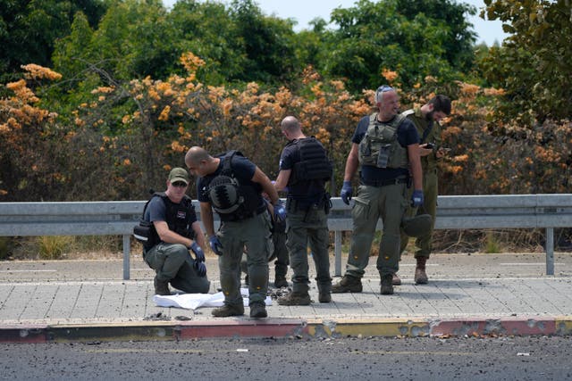 Israeli Police work at the site of a drone strike in Nahariya, Israel 