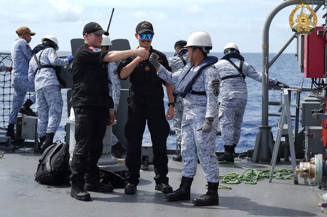 Fist-bumps on deck as navy personnel meet