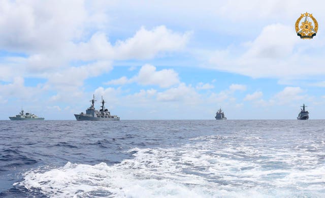 Vessels glimpsed from the stern of a fast-moving boat 