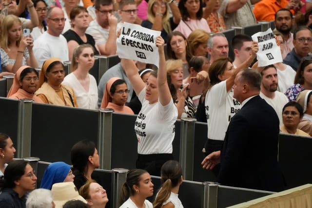 Protesters wear t-shirts reading 'stop blessing corridas' 